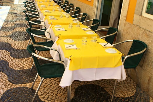 empty tables in street cafe