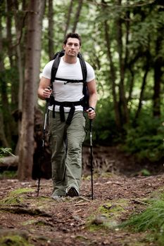 A male backpacking in the forest on a camping trip