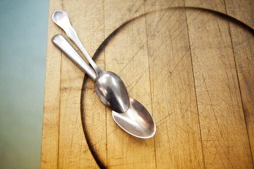Two old spoons in a kitchen abstract detail