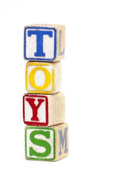 Wooden toy block stacked up to spell the word 'Toys'