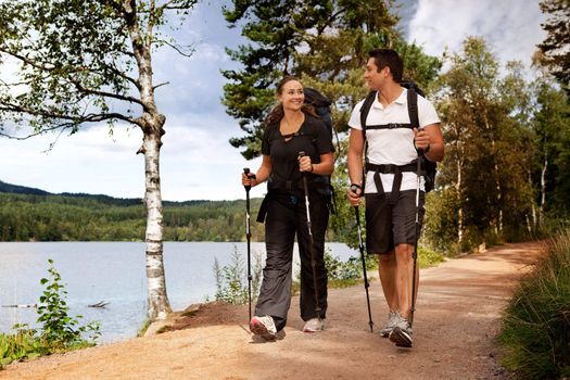 A couple walking on trail with backpacks