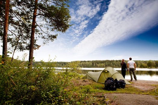 A couple camping on a lake landscape