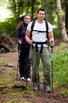 A man and woman on a camping trip in the forest.