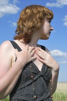 young woman, profile on background sky