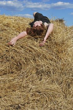 the beautiful woman is relax on the hay