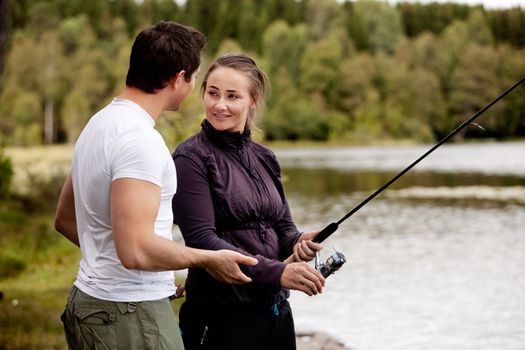A woman fishing - showing a man