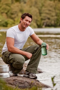 A man fetching water on a camping trip