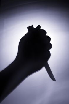 the hand of a murder is holding the knife