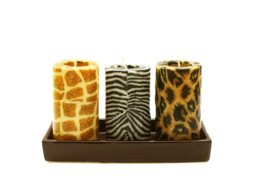 three different candles with animal prints