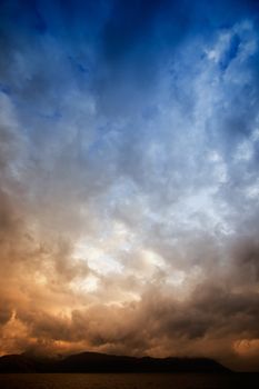 A brewing storm on an ocean sunset