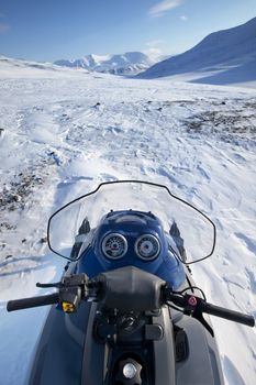 A snowmobile on a winter wilderness landscape