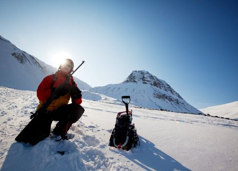 A female adventure loading a rifle as a safety precatuion, Svalbard, Norway