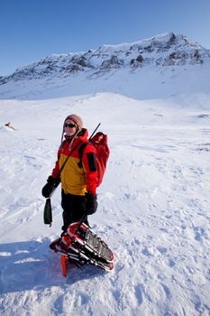 A portrait of a female adventurer against a mountain landscape