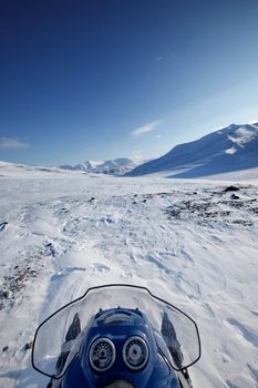 A snowmobile on a winter wilderness landscape