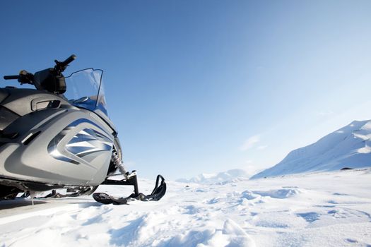 A snowmobile on a winter wilderness landscape