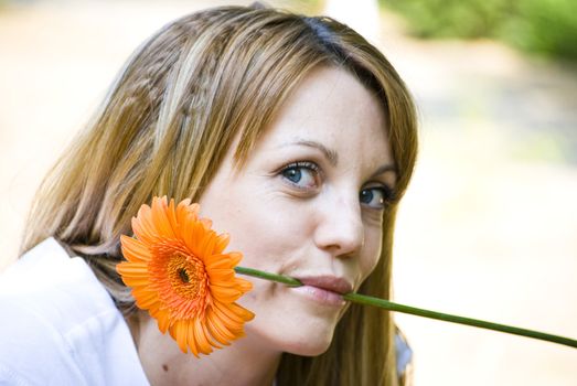 beautiful young blonde woman with flower