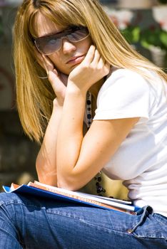 beautiful young woman reading book outdoor