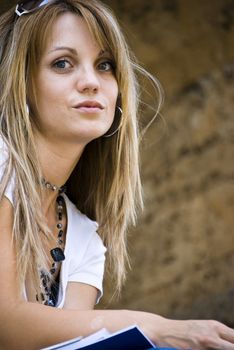 beautiful young woman reading book outdoor