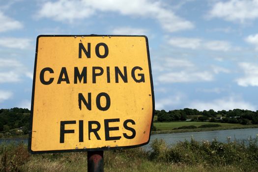 a no camping no fires sign in knockanore county waterford in the south of ireland in summer on the blackwater river edge