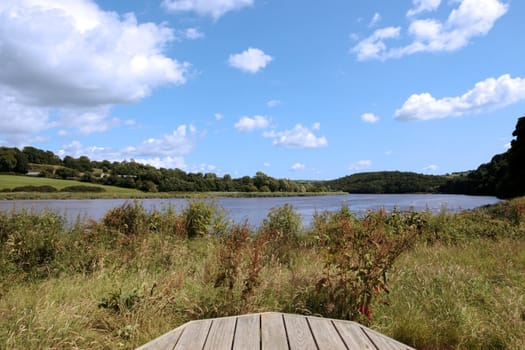 a picnic bench in knockanore county waterford in the south of ireland in summer on the blackwater river edge
