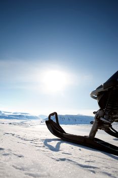 Snowmobile against a deep blue sky