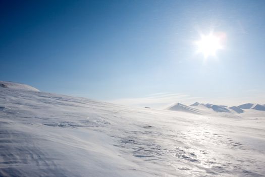 A winter landscape with blowing snow on Spitsbergen Island, Svalbard, Norway