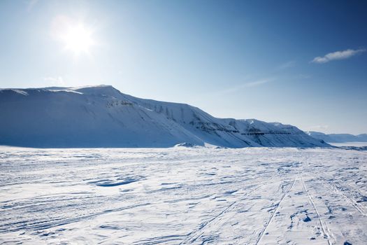 A beautiful winter landscape with a mountain and deep blue sky