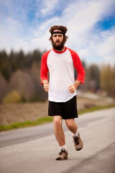 A tired retro style jogger running on a road outdoors