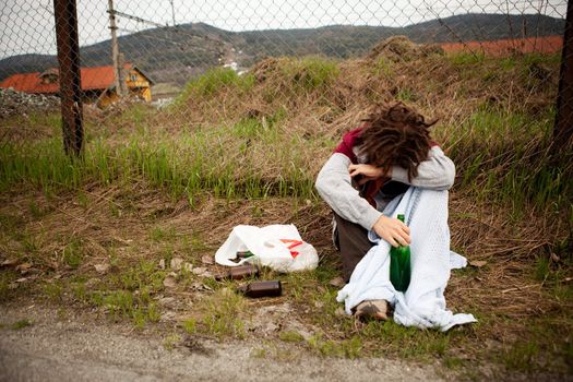 A homeless person sleeping in the ditch