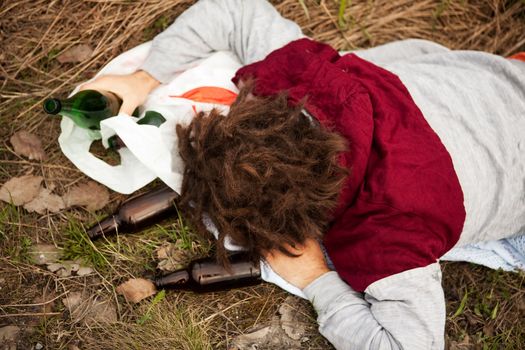 A homeless person sleeping in the ditch