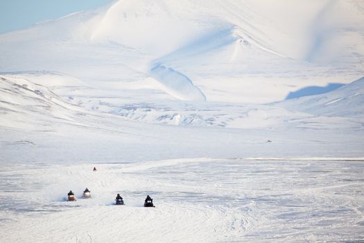 A group of snowmobiles on the ice outside Longyearbyen, Svalbard Norway