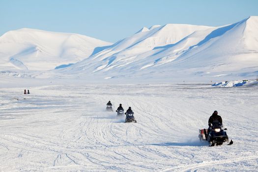 A group of snowmobiles on the ice outside Longyearbyen, Svalbard Norway