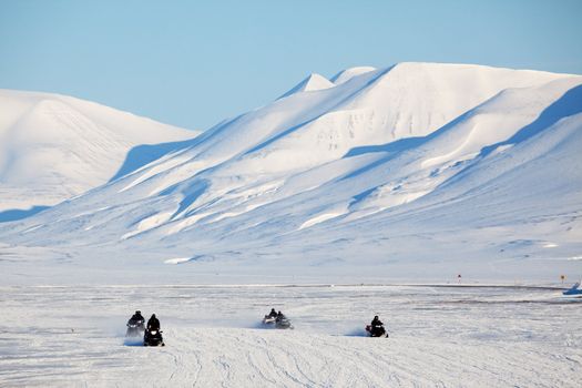 A group of snowmobiles on the ice outside Longyearbyen, Svalbard Norway