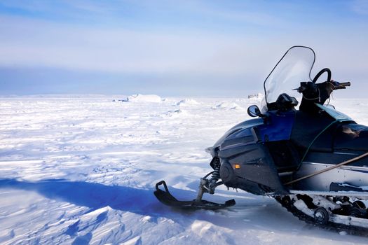 A snowmobile on a barren winter landscape