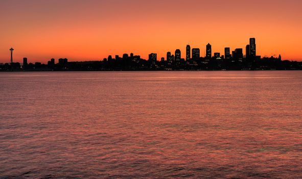 Silhouette of Seattle skyline before sunrise from Alki point