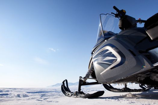 A snowmobile detail on a barren winter landscape