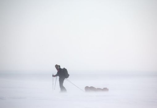 A single person on a winter expedition in a snow storm