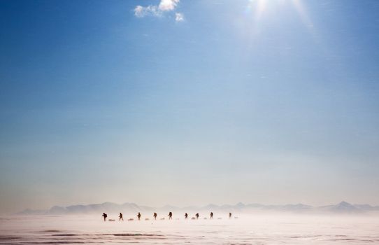 A group of people on a polar expedition in a snow storm