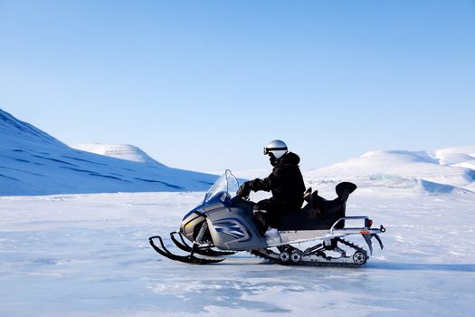 A snowmobile on a beautiful winter mountain landscape