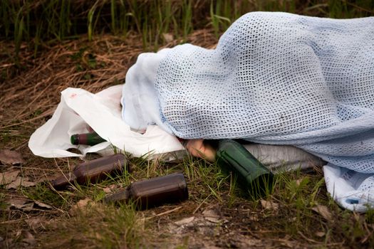 A homeless man with a number of beer bottles