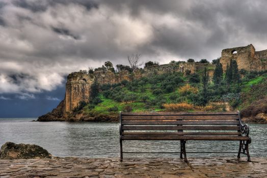 Picture of the venetian castle of Koroni in southern Greece, with a bench in the foreground. 