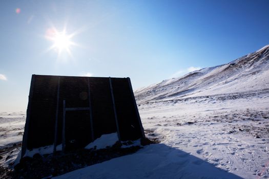 A small shelter on a barren northern landscape