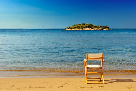 A chair on a sandy beach offering a place to enjoy the view and serenity of the location