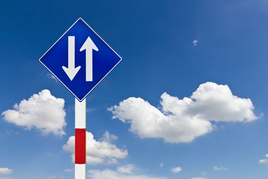 Curved Road Traffic Sign over blue sky