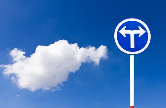 Curved Road Traffic Sign over blue sky,turn left or turn right