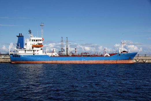 The tanker is moored in the port and loaded fuel