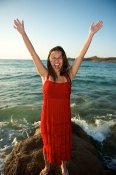 retty young woman relaxing on the beach with a free feeling