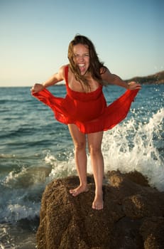 Pretty girl screaming on the beach during her vacation