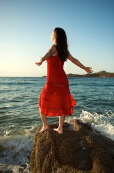 retty young woman relaxing on the beach with a free feeling