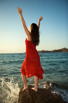 retty young woman relaxing on the beach with a free feeling